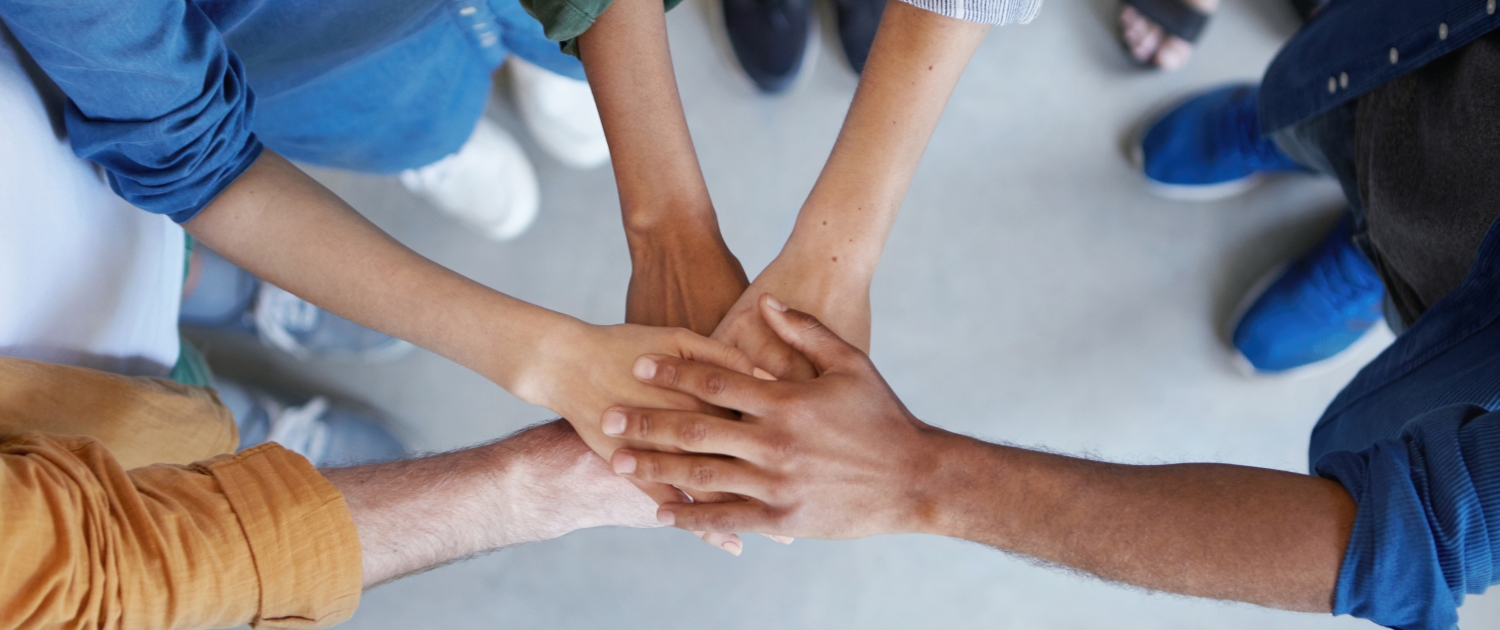 Solidarity and unity conept. Cropped shot of business partners holding their hands together expressing their agreement. True friends keeping their hands together swearing always help each other